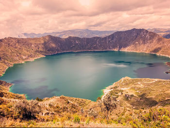 Scenic view of lake against cloudy sky