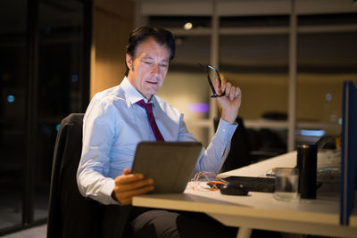 Businessman holding digital tablet at office