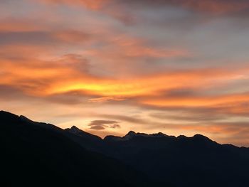 Scenic view of silhouette mountains against sky during sunset