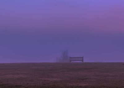 Scenic view of field against sky during foggy weather