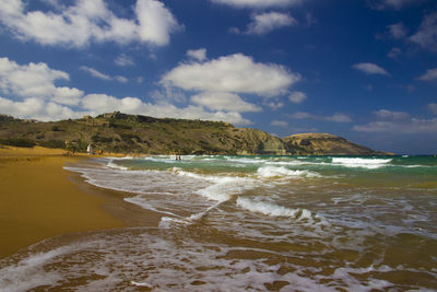 Scenic view of beach and mountains against sky