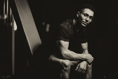 Portrait of young man sitting at home