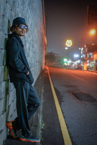 Low angle view of man walking on road at night