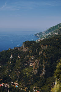 High angle view of trees and sea against sky