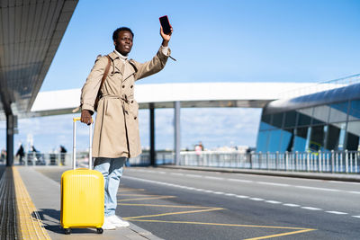 Man standing on bridge against sky