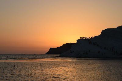 Scenic view of sea against orange sky