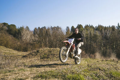 Senior motocross driver riding on circuit