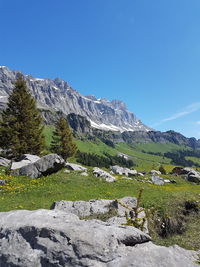 Scenic view of mountains against clear blue sky