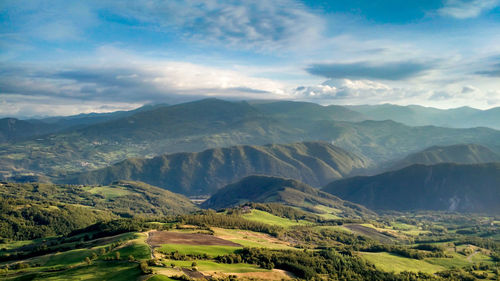 Scenic view of mountains against cloudy sky