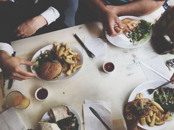 Cropped image of men having lunch at table