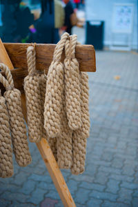 Close-up of rope tied to pole on street