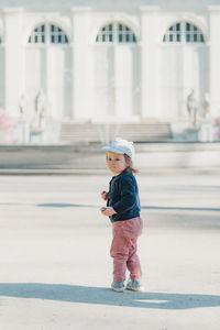 Full length of boy walking on street