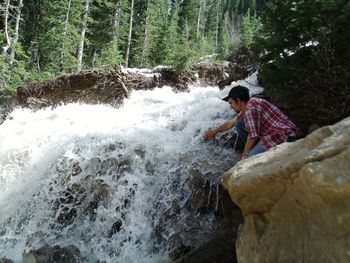 Full length of young man standing on rock