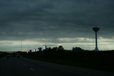 Empty road against cloudy sky