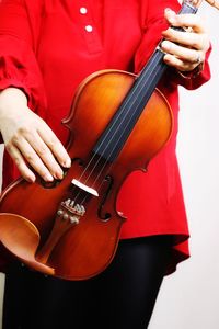 Midsection of woman playing violin