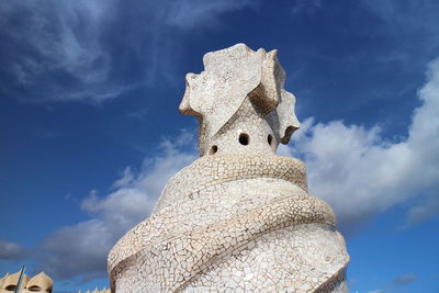 Low angle view of statue against blue sky