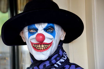 Close-up portrait of mature man with clown make-up