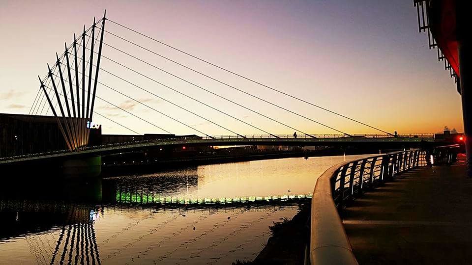 VIEW OF SUSPENSION BRIDGE OVER RIVER