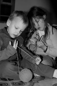 Siblings knitting at home