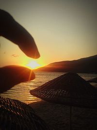 Sun shining through clouds over sea