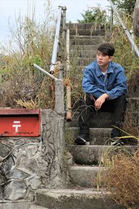 Portrait of young man working in yard