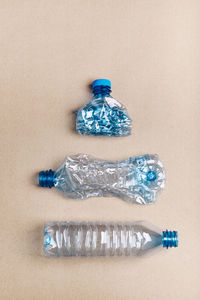 High angle view of plastic bottle against colored background