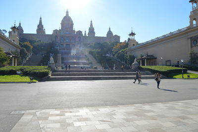 People walking in temple against sky