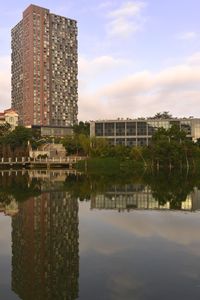 Reflection of buildings in lake against sky