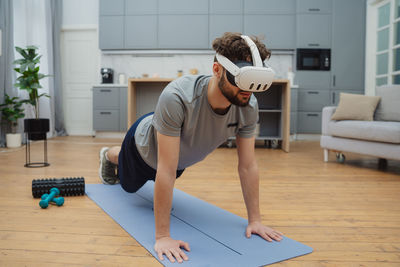 Side view of woman using laptop while sitting on table