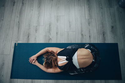 Yogic woman practicing in yoga studio