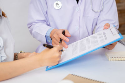 Midsection of woman using mobile phone