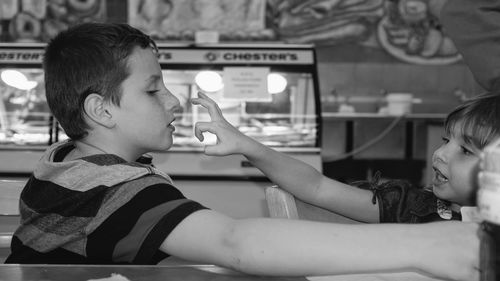 Siblings enjoying at restaurant