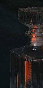 Close-up of glass bottle against black background