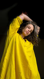 Portrait of woman with yellow hair against black background