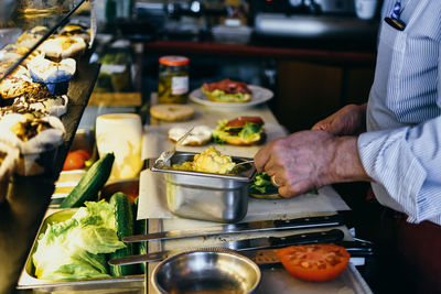 Midsection of man preparing food in kitchen at home