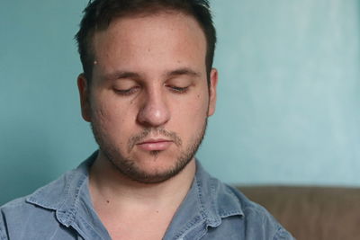 Portrait of young man against white background