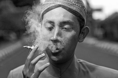 Portrait of man smoking cigarette