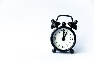 Close-up of alarm clock against white background