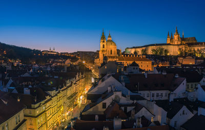 High angle view of city lit up against sky