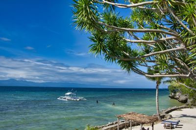 Scenic view of sea against sky with a boat