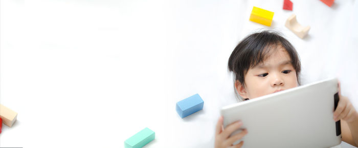 Portrait of girl holding mobile phone