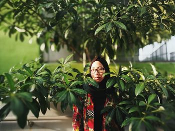 Portrait of woman amidst plants