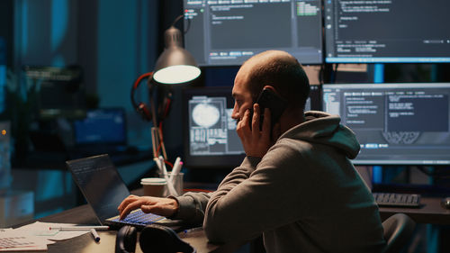 Midsection of woman using mobile phone while sitting in office