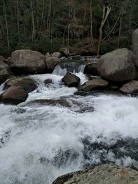 Scenic view of river flowing through rocks