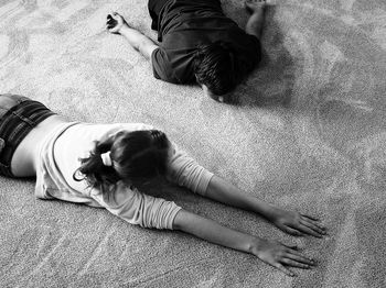 High angle view of friends relaxing on floor