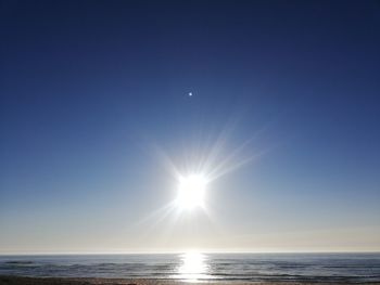 Scenic view of sea against blue sky