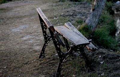 High angle view of empty bench on field