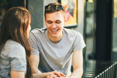 Happy young woman sitting outdoors