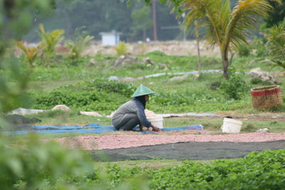 Side view of man working at park