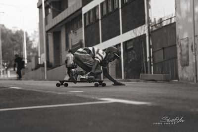 Man skateboarding on street in city